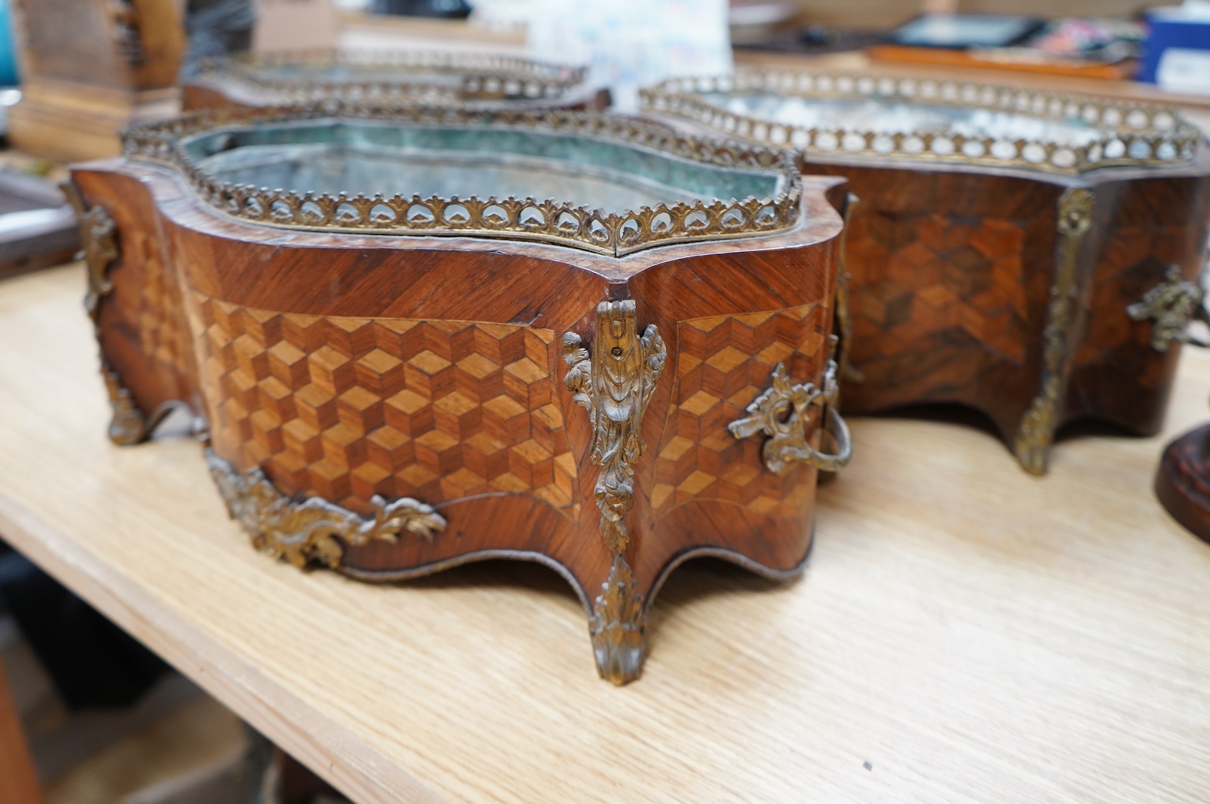 A pair of French Transitional style kingwood and parquetry table jardinières and one other, 43cm wide